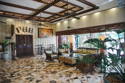 a living room with a couch and a table at Oasis Hotel in Angeles