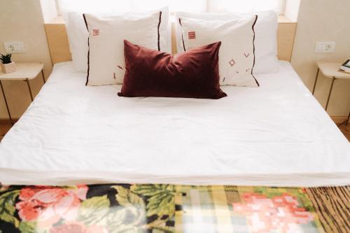 a bed with white sheets and pillows on it at Porumbacu134 in Porumbacu de Sus