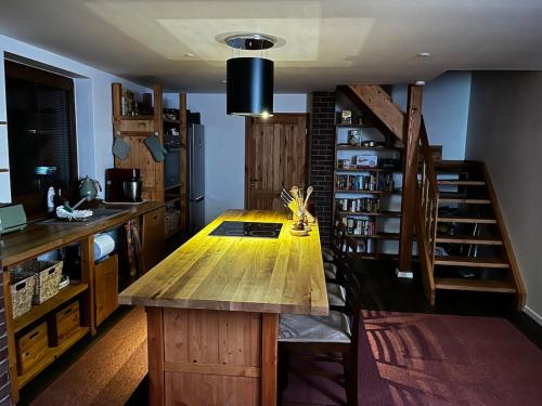 a kitchen with a wooden table in a room at Cozy getaway with SPA in nature in Stankovany