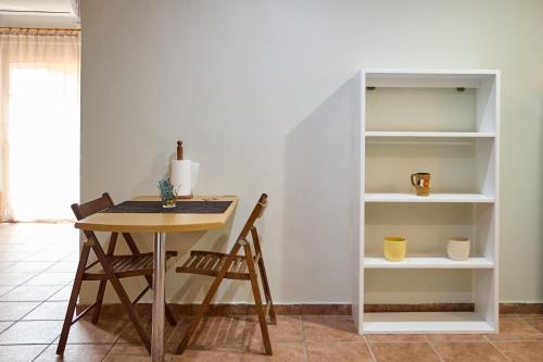 a dining room with a table and a book shelf at Μεζονέτα AIKATERINI N 7 in Chios