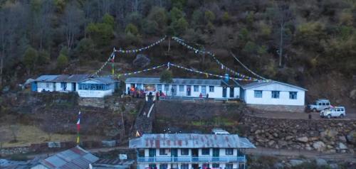 a group of buildings on the side of a hill at Potala Homestay in Syābru Bensi