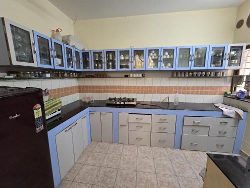 a kitchen with blue cabinets and blue counters at Blue Haven Villa - Luxurious 3BHK Stay in Jodhpur