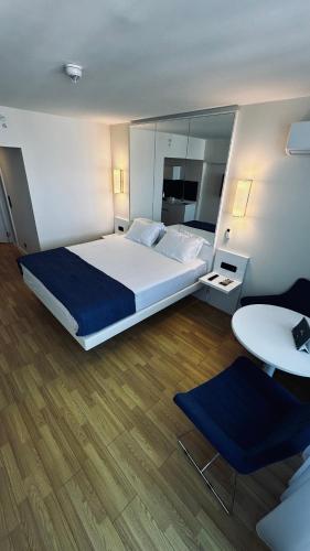 a bedroom with a large bed and a table at Orbi City Hotel D1 Block in Batumi