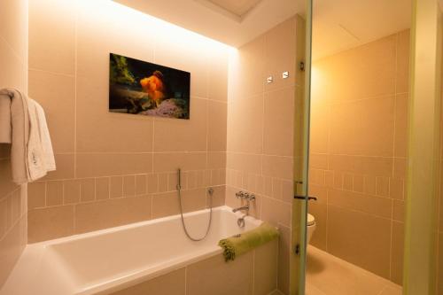 a bathroom with a bath tub and a toilet at LEscapade at St Regis Saadiyat in Abu Dhabi