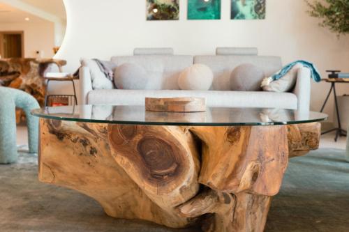 a coffee table made out of a wooden tree stump at LEscapade at St Regis Saadiyat in Abu Dhabi