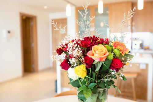 a vase filled with colorful flowers on a table at LEscapade at St Regis Saadiyat in Abu Dhabi