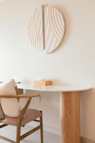 a white table with a chair and a mirror at LEscapade at St Regis Saadiyat in Abu Dhabi
