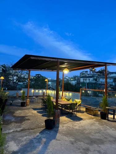 a pavilion with a table and chairs on a patio at LƯNG CHỪNG Home in Xuan An