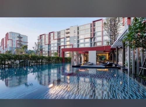 a large swimming pool in front of a building at D Condo phuket kathu- patong in Amphoe Kathu