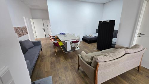 a living room with a couch and a table at Work & Family Apartment Herzogenaurach in Herzogenaurach
