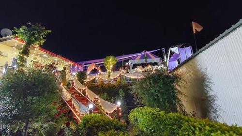 a view of a building with lights at night at The Pines Mountain View in Rudraprayāg