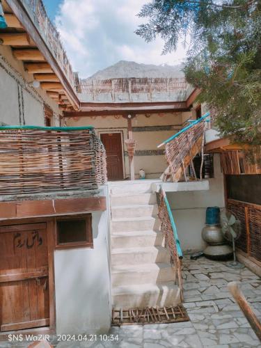 a house with stairs leading up to a building at Areshman Organic Guest House & Hotel in Kuru
