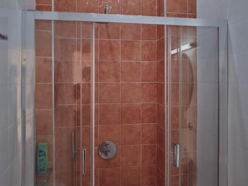 a shower with a glass door in a bathroom at Studio Lefaki in Rethymno Town