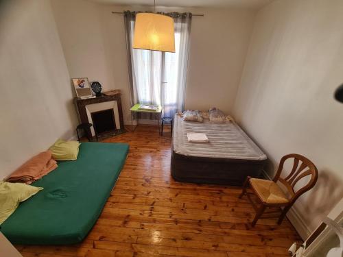 En eller flere senge i et værelse på T4 chaleureux en plein centre