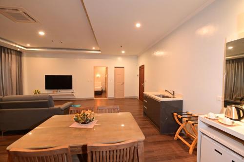 a living room with a table and a couch at T Shine Resort and Spa in Mactan