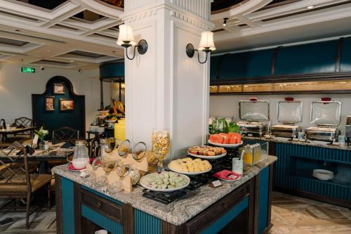 a buffet in a restaurant with food on a table at GRAND HOTEL du LAC Hanoi in Hanoi