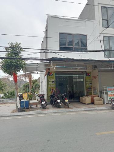 two motorcycles parked in front of a building at Zon homestay & restaurant in Cat Ba