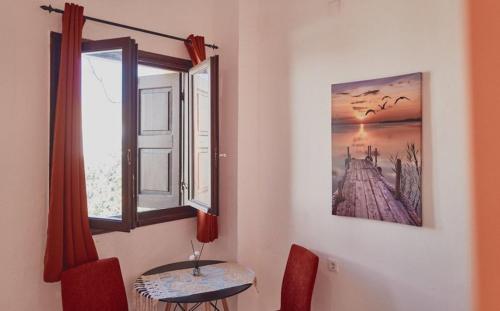 a dining room with a table and a window at Studio Lefaki in Rethymno Town