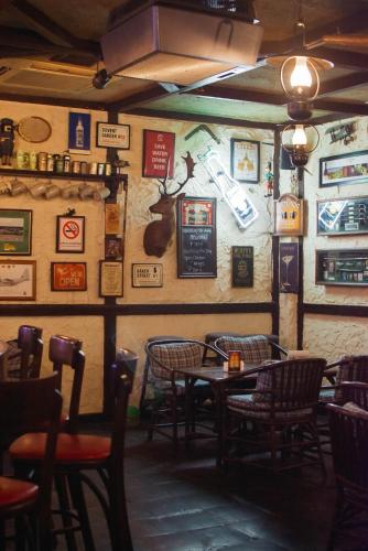a restaurant with tables and chairs and signs on the wall at Oasis Hotel in Angeles