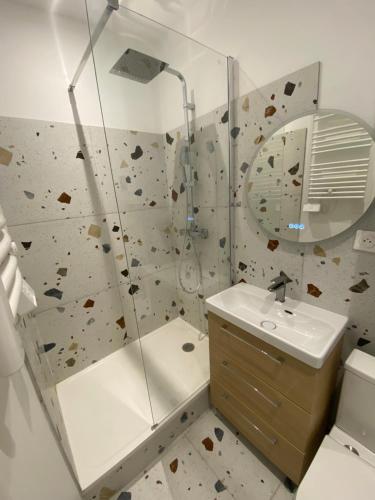 La salle de bains est pourvue d'un lavabo et d'un mur en pierre. dans l'établissement Studio Calme au centre ville, à Toulouse