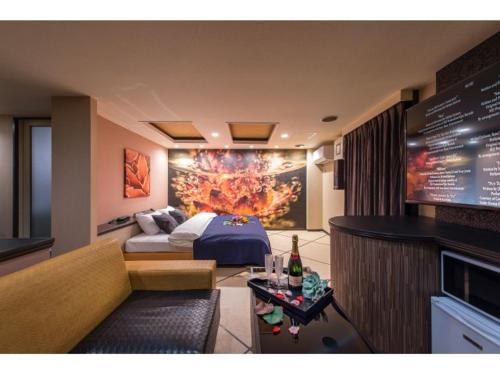 a hotel room with a bed and a couch at ホテル椿for adalt in Yokohama