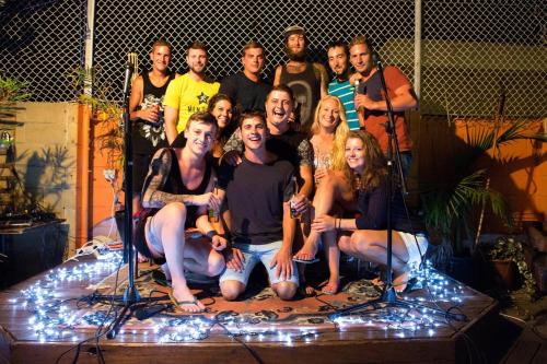 a group of people posing for a picture on a stage at Old Fire Station Backpackers in Fremantle