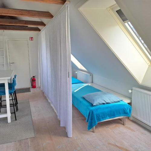 a bedroom with a bed and a table in a room at The 'Loft' - Boutique Guest House - near Rønne & Beach in Rønne