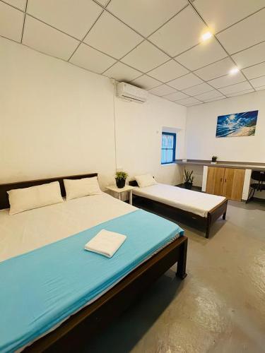 a bedroom with two beds in a room at Liyaa Blue Beach Weligama in Weligama
