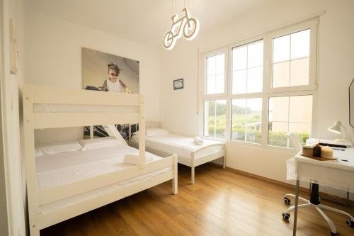 a bedroom with two bunk beds and a desk at Ingrit Gjoni Villas in Draçi