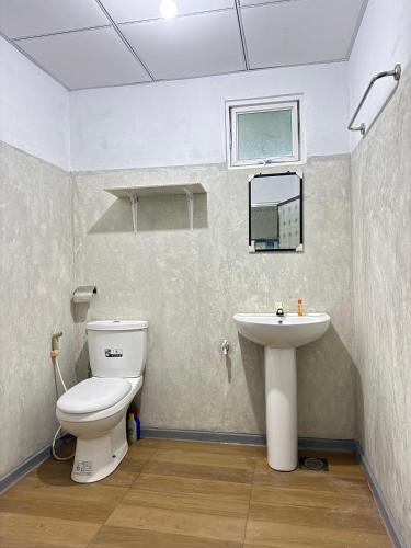 a bathroom with a toilet and a sink at Liyaa Blue Beach Weligama in Weligama