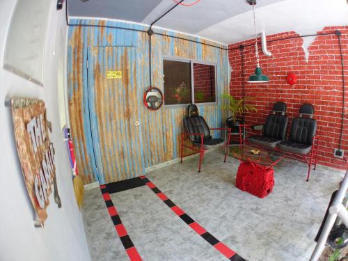 a room with a table and chairs and a brick wall at Takatuka Beach Resort in Sipalay