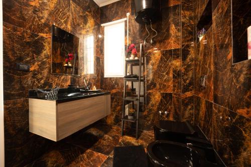 a bathroom with a sink and a mirror at Ingrit Gjoni Villas in Draçi