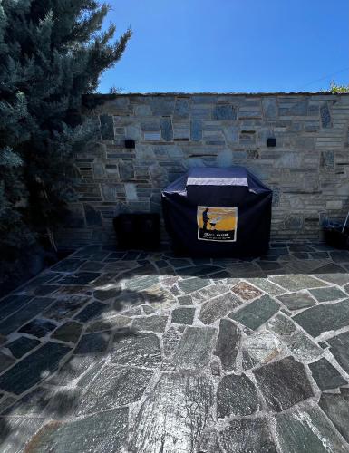 a stone wall with a box on a patio at One Bedroom Pool House by Olivujoj in Anavissos