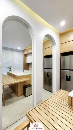 a kitchen with white walls and an archway in a room at The LuxHomes Apartment ᵀᴹ I HOT Độc Đáo Nhất Vinhomes Marina in Hai Phong