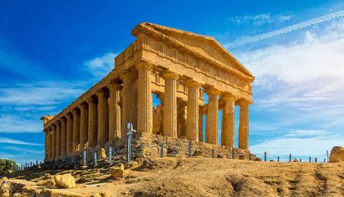 an ancient temple with columns on a hill at La Terrazza sul Faro in Porto Empedocle