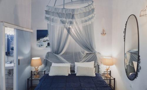 a bedroom with a blue bed with a canopy at Studio Lefaki in Rethymno Town