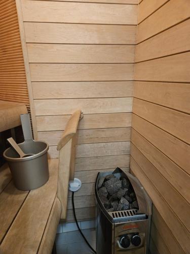 a small sauna with a wood stove in it at Asuntoni keskustassa in Tampere