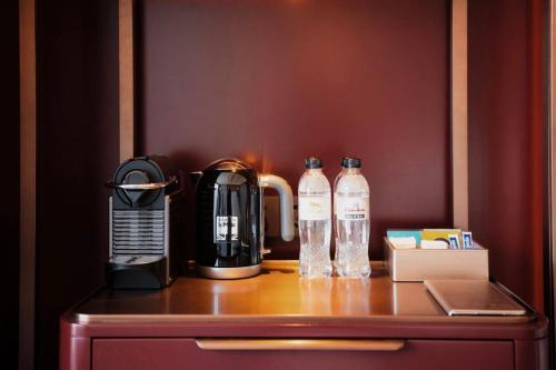a coffee maker and two bottles of water on a counter at MGM Qingdao in Qingdao