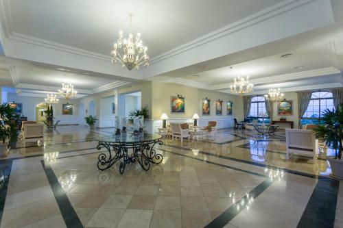 a large lobby with a table and chairs in it at Eurostars Grand Cayacoa in Santa Bárbara de Samaná