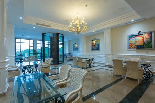 a waiting room with tables and chairs and a chandelier at Eurostars Grand Cayacoa in Santa Bárbara de Samaná