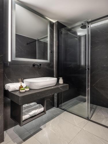a bathroom with a sink and a shower at Urban K in Athens