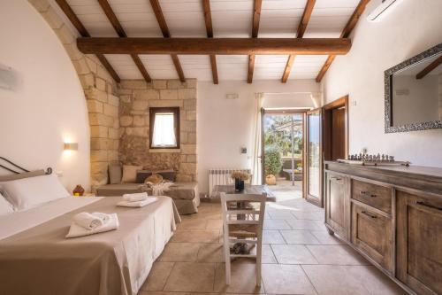 a bedroom with a bed and a sink in a room at Agriturismo Alonì Costarella Masseria in Borgagne