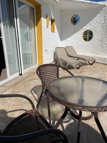 a patio with a table and chairs on a porch at Hotel Rural los Caracoles in Frigiliana