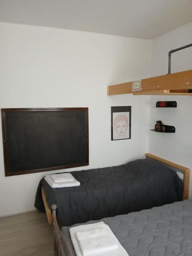 a bedroom with a bed and a flat screen tv at MUN Apartment City - Major Unforgettable Nights in Bergamo