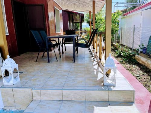 a patio with a table and chairs on a house at The Beach house in Platanitis Rodopis