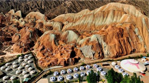 a model of a mountain with a group of houses at KaoShan Tent Zhangye in Zhangye