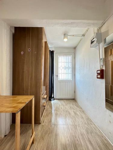an empty room with a table and a door at Chubby 9 Standard room in Ban Bang Phlat