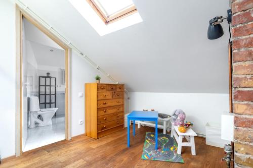 a room with a blue table and a bedroom at Large and cozy 2-level apartment in Tallinn