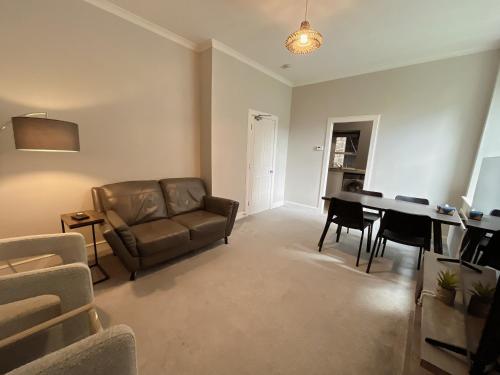 a living room with a couch and a table at Two bed apartment in Edinburgh