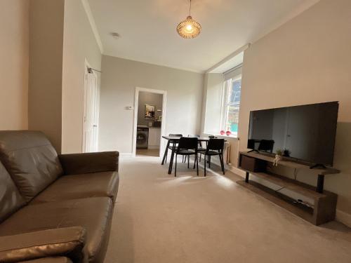 a living room with a couch and a table at Two bed apartment in Edinburgh